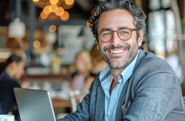 Smiling Man Sitting in Front of Laptop