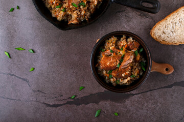 Meat with buckwheat served in the cast iron pan and bowl. Nutritious meal for lunch or dinner. Top view