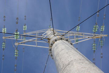 power line on a concrete pole against a blue sky
