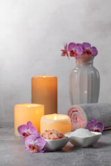 Sea salt, towels, orchid flowers, and burning candles.