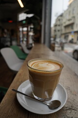 Solitude Brew: Coffee Amidst Empty Seats and a Glimpse Outdoors