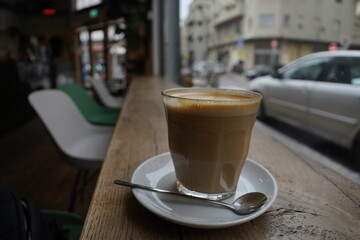 Solitude Brew: Coffee Amidst Empty Seats and a Glimpse Outdoors