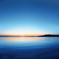 A beautiful blue ocean with a sunset in the background