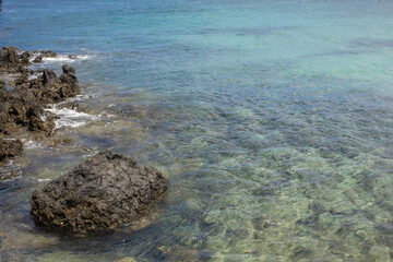 marine view. Turquoise ocean. Rocks on the coast. Calm sea. Village of Arrieta. Lanzarote, Canary Islands, Spain