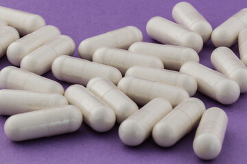 A stack of supplement capsules, dietary supplements, vitamin tablet, nutritional supplements in capsule form.