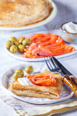 Pancakes with gravlax, cottage cheese and olives. A traditional dish for Maslenitsa or Carnival. - 754313097