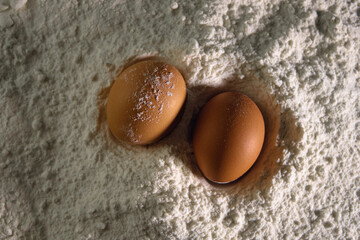 chicken eggs lie in flour close-up