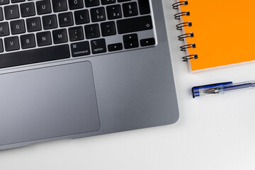 Laptop with block notes and pen