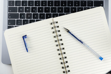 Laptop with block notes and pen