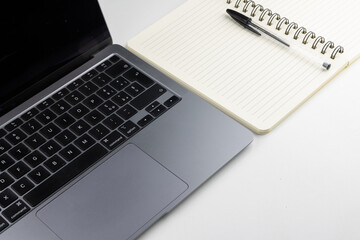 Laptop with block notes and pen