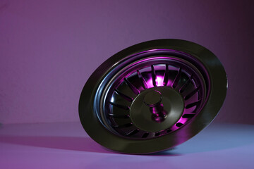 washbasin drain with strainer on purple background
