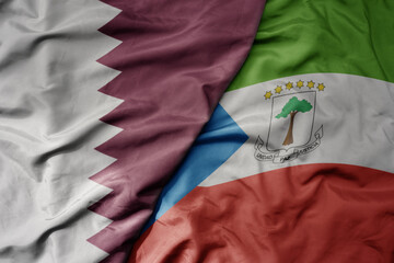 big waving national colorful flag of equatorial guinea and national flag of qatar.