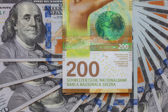 Closeup of  200 Swiss franc banknote and 100 dollar banknote