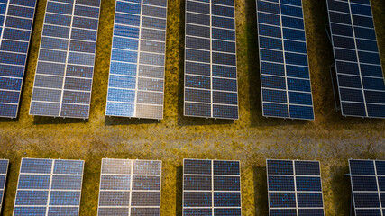 Solar Photovoltaic of solar farm aerial view, solar plant rows array of on the water mount system Installation in earthen pond, Floating solar or floating photovoltaics (FPV). evening sky