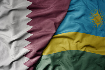 big waving national colorful flag of rwanda and national flag of qatar.