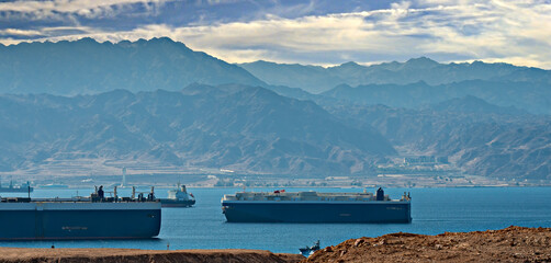 Red Sea, straits and gulfs, numerous international cargo ships moored off due to Middle Eastern safety concerns, unstable politic situation - obrazy, fototapety, plakaty