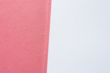 rough textured pink paper with crease fold and staple holes and textured paper