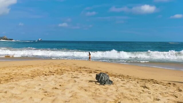 Sexy female tourist traveler woman girl walks swims Mazunte Mexico.
