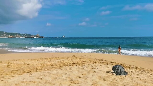 Sexy female tourist traveler woman girl walks swims Mazunte Mexico.