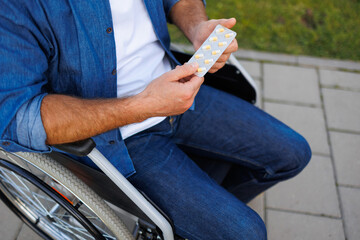 Disabled Man Holding Medication