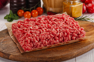 Raw minced beef meat over board