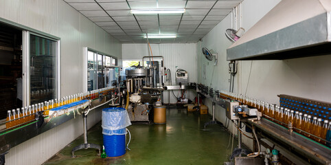 At the beverage factory an efficient bottling line packs basil seed and pomegranate-infused healthy...