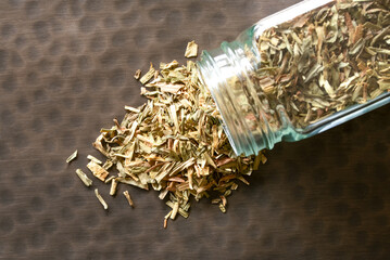 Dried Tarragon Herb Spilled from a Jar - 754375288