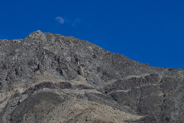 Moonrise in daylight Mojave desert.