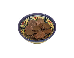 some euro pennies in a decorated bowl