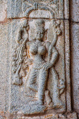 Detail of stone carvings of Apsara,  a beautiful and seductive girl of Hindu mythology, Varaha temple in Hampi, Karnataka, India, Asia