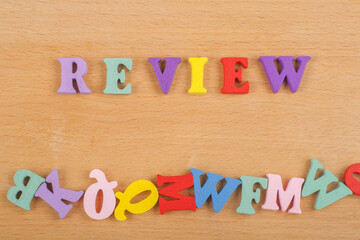 REVENUE word on wooden background composed from colorful abc alphabet block wooden letters, copy...