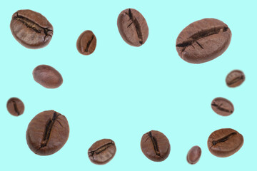 Falling coffee beans isolated on background. Flying defocused coffee beans. Used for cafe advertising, packaging, menu design.