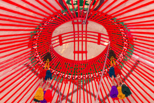 Yurt interior. Shanyrak impotant element of traditional Kyrgyz tent. Tunduk symbol in center of Kyrgyzstan national flag. National decoration on roof Embroidery and patterns of nomads central Asia.