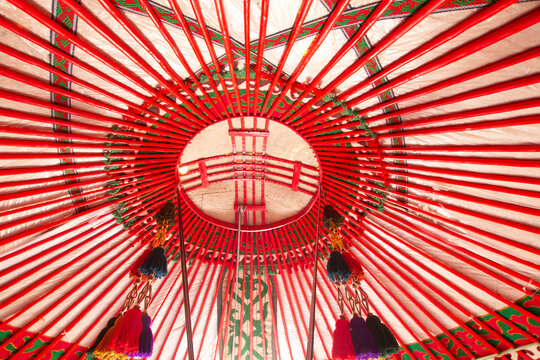 Yurt interior. Shanyrak impotant element of traditional Kyrgyz tent. Tunduk symbol in center of Kyrgyzstan national flag. National decoration on roof Embroidery and patterns of nomads central Asia.