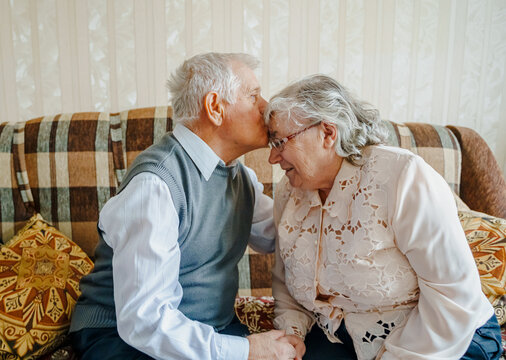 Elderly senior romantic love couple. Old retired man woman together. Aged husband wife in cozy home sweater.Elder hugging kissing people pensioner.Happy family longevity.Tender feelings relationships
