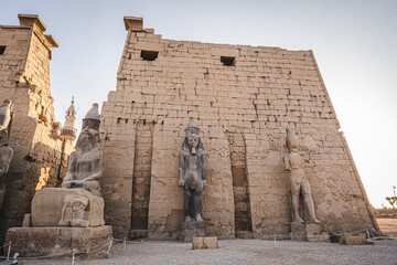 Luxor, Egypt - October 27, 2022. Statues seen on the main entrance of the Luxor Temple during the sunset. - 754408400