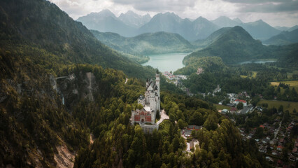 Aerial shot of Bavaria area in Germany, Neuchwanstein Castle,  Alpsee Lake,  Tegelberg and  Säuling Mountains