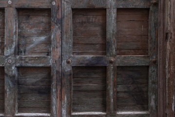 An old paneled wooden door with metal nails