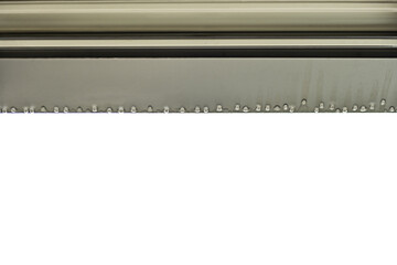 Drops of rainwater suspended from the edge of a window