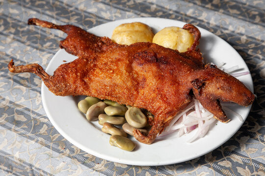 Peruvian Cuy Chactado is a traditional dish that features guinea pig, a delicacy in Peruvian cuisine, typically prepared by frying it until crispy.