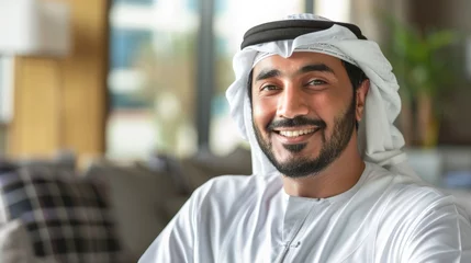 Fotobehang Happy Emirati Arab at office wearing Kandura looking at front ideal for Middle East business concept © Sasint
