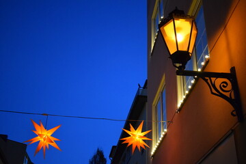 Yellow street lamp and star shaped Christmas lights