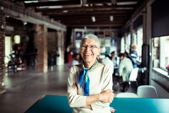 Happy smiling senior woman portrait in startup office