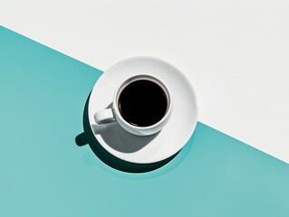 top view of a white cup of black coffee on a white and blue minimalist background