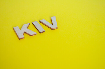 KIV wooden letters representing Keep In View on yellow background