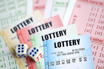 Lottery tickets of different colors and dice on blank bills with numbers for playing lottery close...