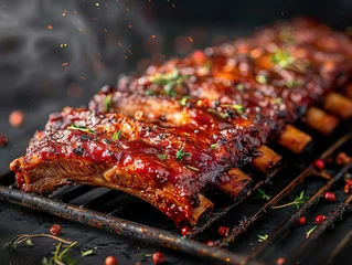 Foto op Plexiglas Spicy hot grilled spare ribs from a summer BBQ served with a hot chili pepper and fresh tomatoes on an old vintage wooden cutting board © Mister