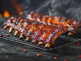 Keuken spatwand met foto Spicy hot grilled spare ribs from a summer BBQ served with a hot chili pepper and fresh tomatoes on an old vintage wooden cutting board © Mister