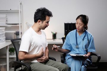 A man is sitting in a chair with a woman doctor looking at him