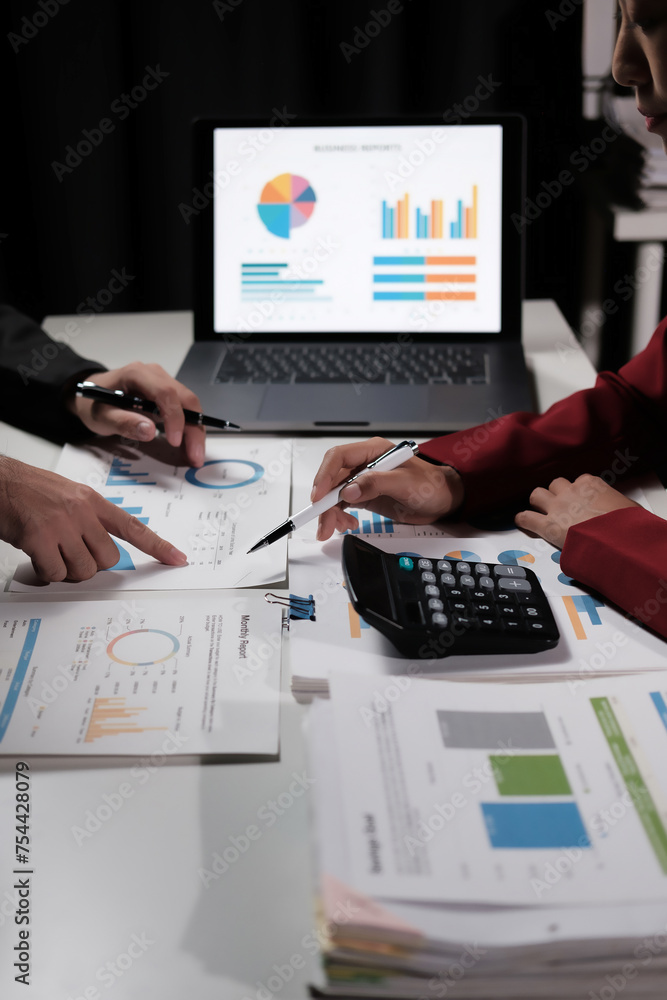 Poster two people are looking at a laptop with a screen showing graphs and charts